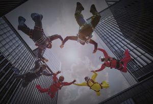 skydivers joining hands to me a circle in the sky.